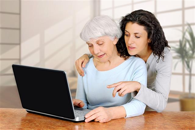 Father and daughter using laptop